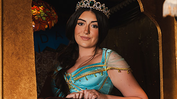 young woman dressed as a princess with a crown in a vibrant setting showcasing themes of fantasy and adventure associated with the number 13