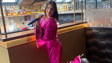 woman in pink outfit singing karaoke at a bar with colorful drinks in the background seven vibrant moments of performance