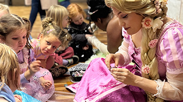 a character dressed as a princess interacts with young children during a storytelling event about the number 17 and magical adventures